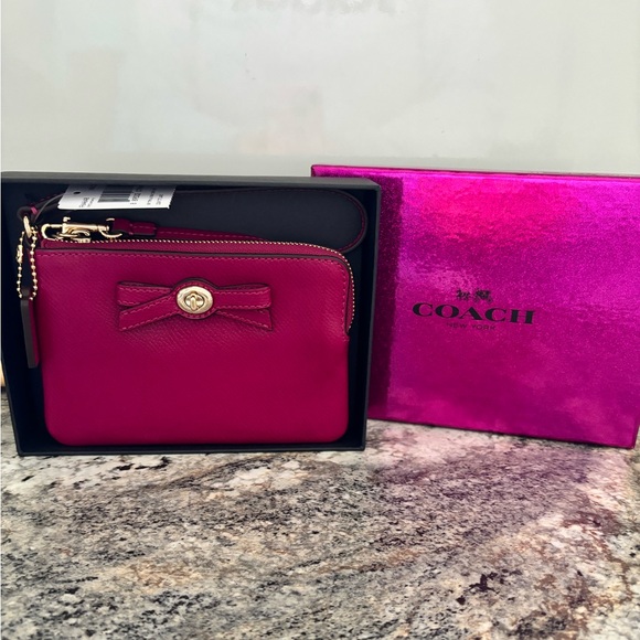 Coach Handbags - Coach Pink Wristlet with Bow Accent